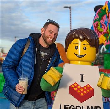 man and lego man stand together